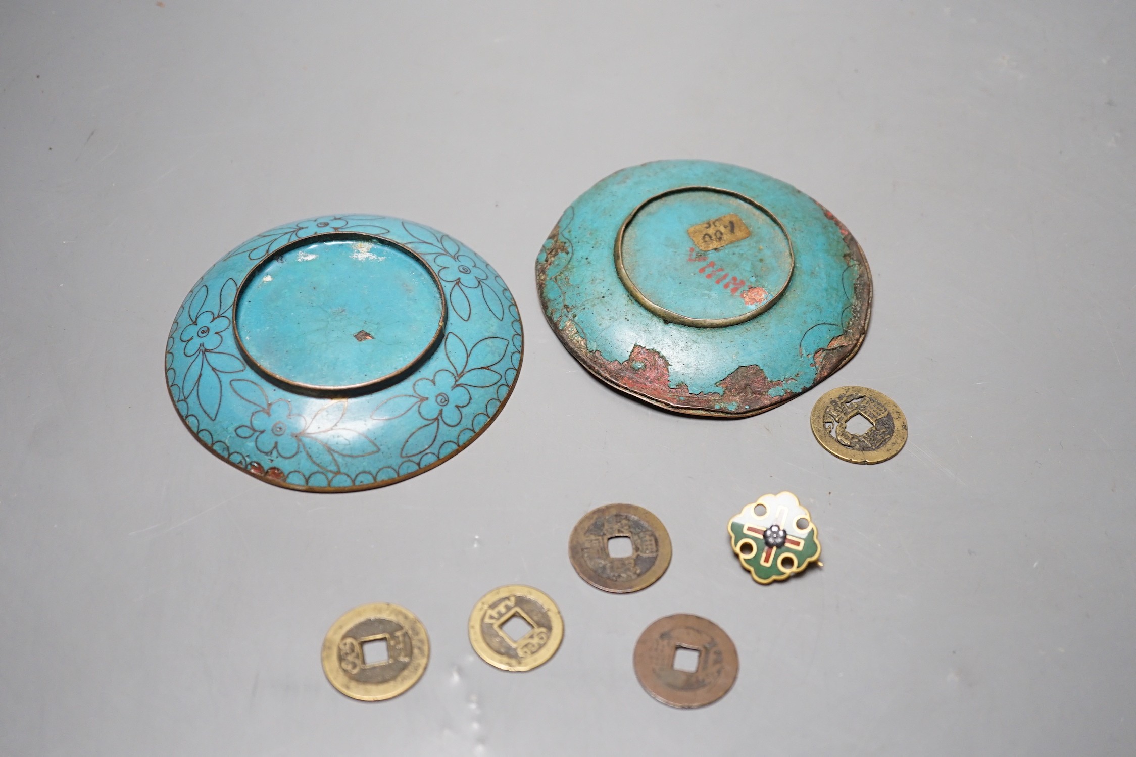 A group of Chinese coins, cloisonné enamel wares and an enamelled badge